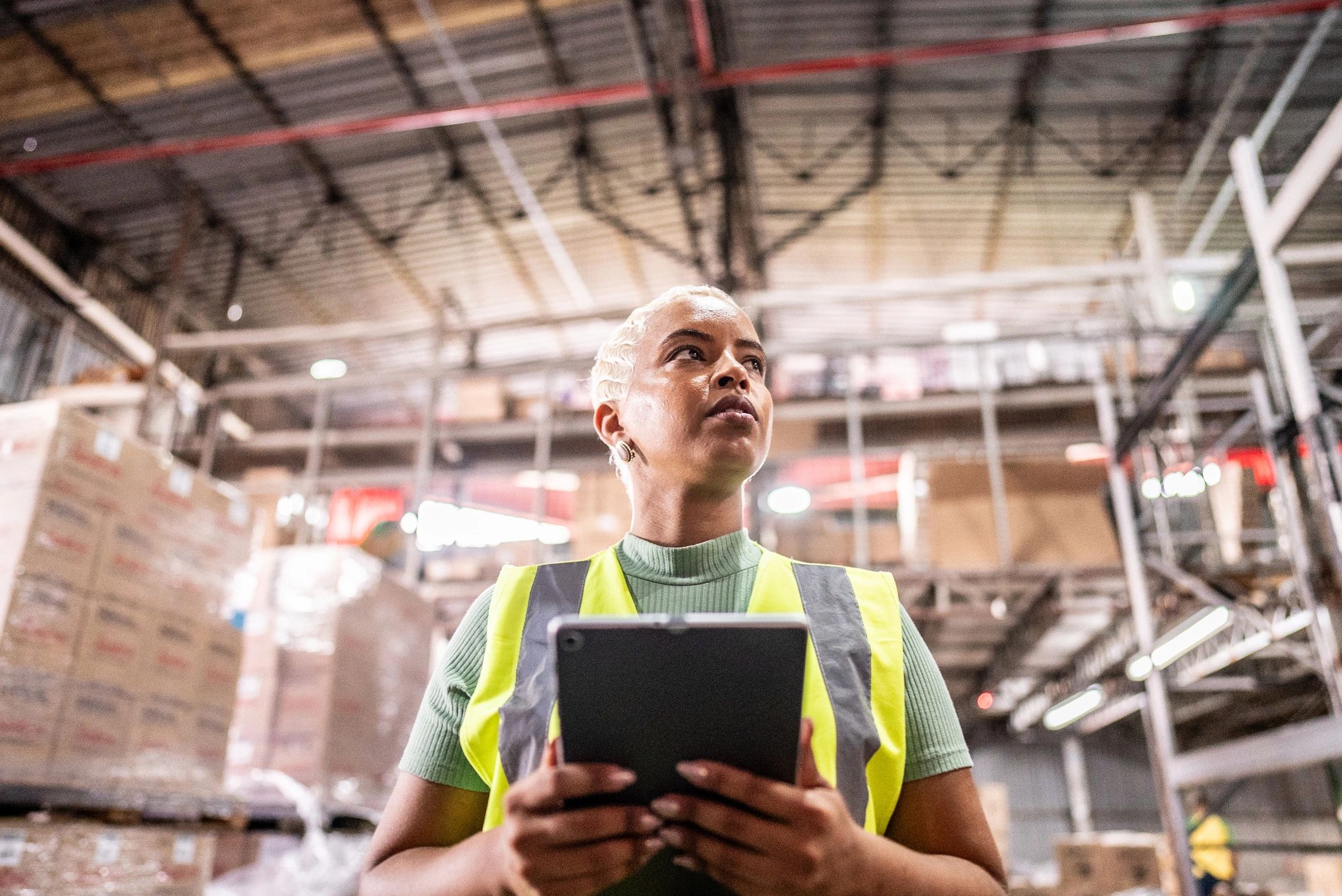 Warehouse staff using a tablet to manage inventory