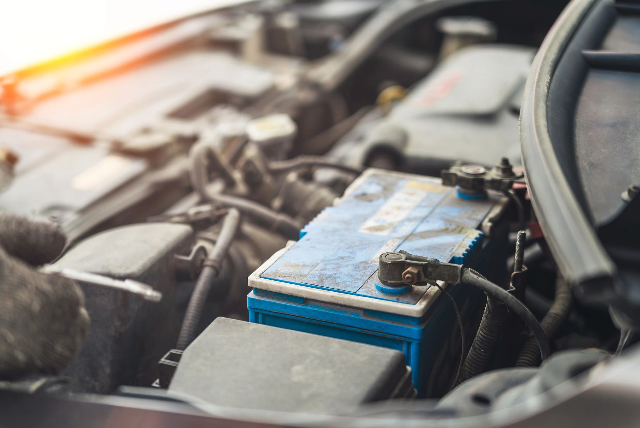 Car battery installed in an engine bay